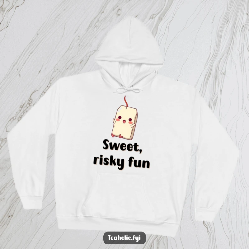 Funny hoodie illustration of a tea bag character bravely attempting to swing from a sugar cube, perfect for cozy, humorous wear.