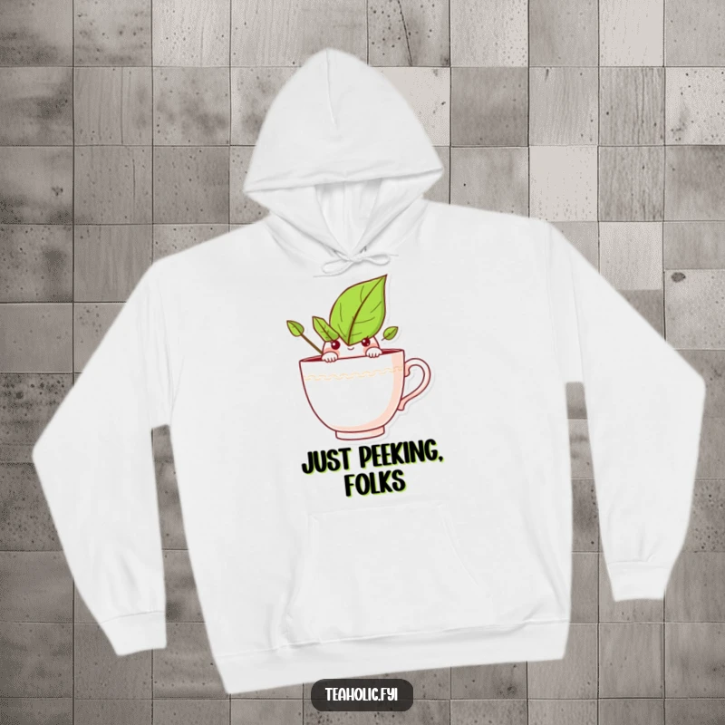 Funny hoodie with a curious tea leaf character peeking over a teacup rim, offering warmth and whimsical charm.