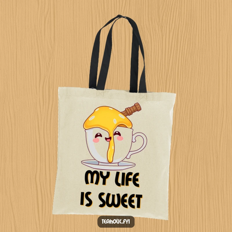Funny tote bag with a happy honey pot character comically dripping onto a teacup handle, great for stylish, humorous carrying.